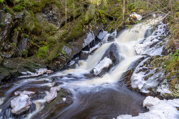 Stunning Frozen Hassafallen Waterfall in Wintry Rural Woodlands outside of Jonkoping Sweden And Nearby Taberg Stream. Sweden Rivers And Waterfalls Wintertime in nature reserve.