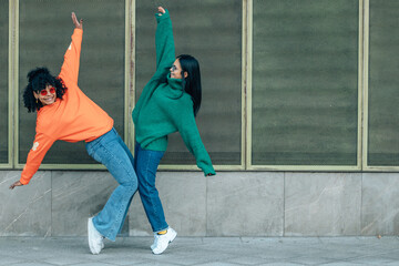 Girls on the street dancing with colored jersey