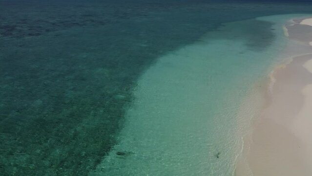 Tropical paradise with blue sea and green island in the maldives