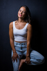 Close up image of a Dark Haired Girl Posing for a Fashion Shoot in a studio