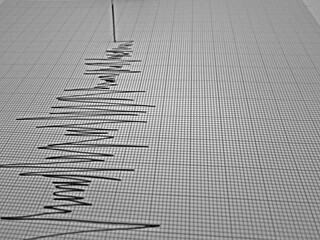 Seismograph and earthquake. A seismograph that records the seismic activity of an earthquake.
