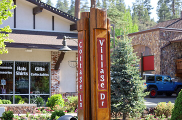 Naklejka premium The Village Mall street wooden signs at Big Bear Lake in southern California.