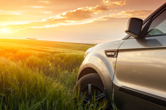 Car travelling. Vehicle on a nature field as concept of eco technology.
