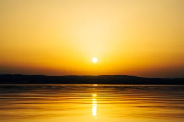 Selbstklebende Fototapeten golden sunset over the lake © NatureScenicLens
