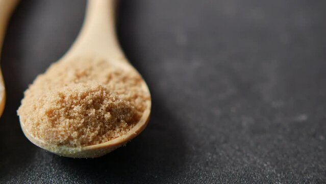 comparing white and brown sugar on table 