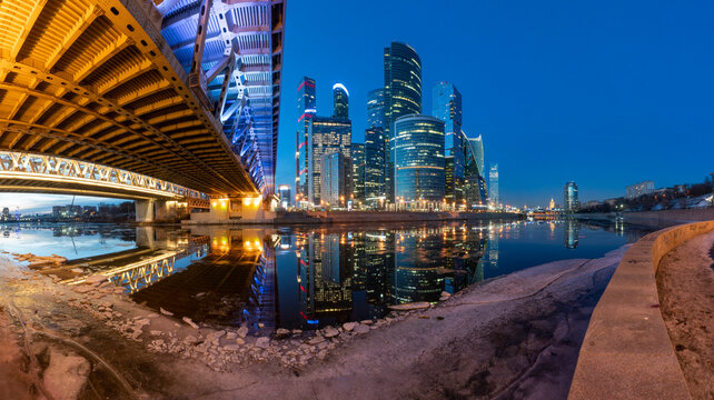 Moscow City and Andreevsky bridge panorama view from the embarkment of Moscow river, march evening