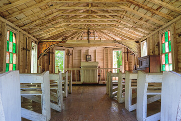 Inside an old southern church with crude painted glass