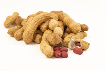 Unpeeled peanut close-up on a white background.