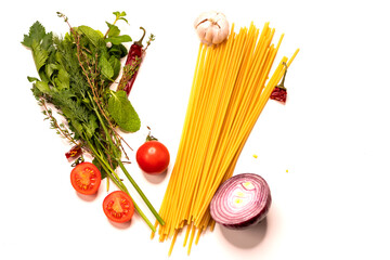 Pasta and various ingredients on a white background. Pasta, spices and tomatoes on a white background.
