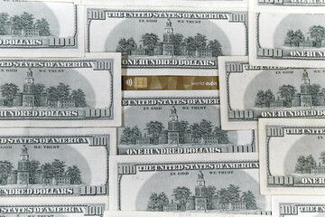 bank card surrounded by hundred dollar bills. U.S. economic profile, economic investment, economic news