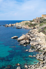 Fototapeta na wymiar Breathtaking view of the picturesque Maltese coastline, where the crystal-clear waters of the Mediterranean Sea meet the stunning rocky cliffs, under the warm and vibrant Maltese sun