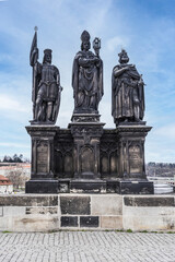 Fototapeta na wymiar Statue of Saints Norbert of Xanten, Wenceslao and Sigismund on Charles Bridge, Prague, Czech Republic.