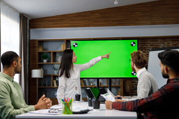 Marketing strategy analysis, stock market trading or corporate teamwork. A team of startups at a table with a large green screen TV. Mixed race business team.