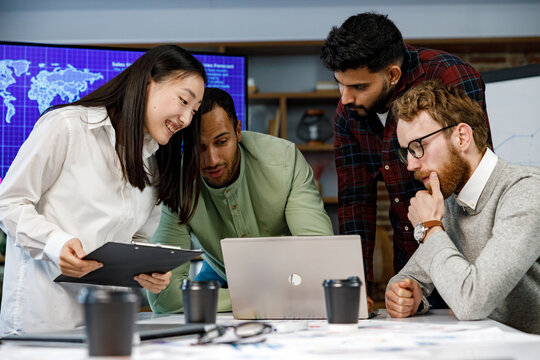 A team of young multinational business people are working on a startup. New generation of startups. communication network. Management strategy. Digital transformation. multinational professional staff