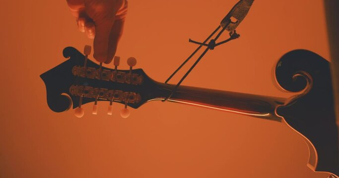 Close up of a musician playing an acoustic f-style mandolion