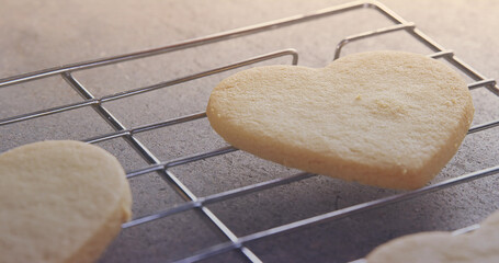 Image of close up of heart shaped cookies with copy space on steel tray