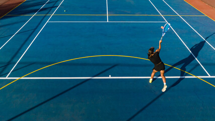 Drone Shot of Young Female Tennis Player on a New Court