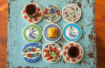 Photograph of Turkish Baklava in Ottoman Tile Turkish Coffee Cup and Turkish Tea Concept, Uskudar...