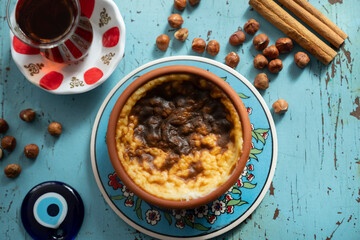 Photograph of Rice Pudding (Turkish Sutlac) in Ottoman Tile Turkish Coffee Cup and Turkish Tea Concept, Uskudar Istanbul, Turkey	