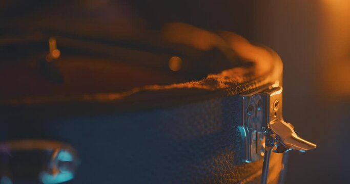 Close up of a musician unbuckling a mandolin case