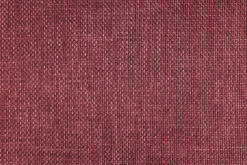 Fototapeta premium Jacquard woven upholstery, red coarse fabric texture. Textile background, furniture textile material, wallpaper, backdrop. Cloth structure close up.
