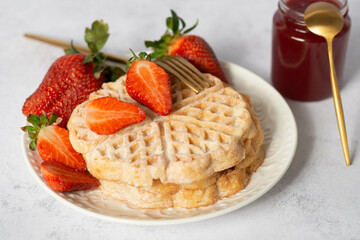 waffles with strawberries in the shape of a heart. food for valentine's day