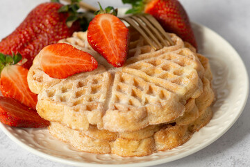 waffles with strawberries in the shape of a heart. Close up, copy space, background