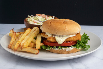 baked haddock sandwich  with  french fries and cole slaw
