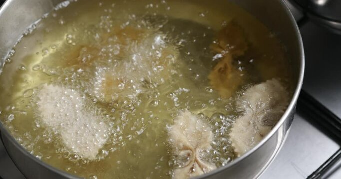 Crisp and delightful: the chebakia frying process, where each piece becomes a golden work of culinary art