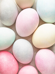 Easter background. Colorful dyed Easter eggs close up. Pastel pale colors. Abstract, top view.