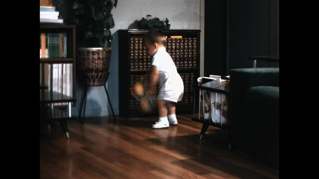 Toddler Living Room 1968 - A toddler plays with a rubber ducky in the family room in the 1960s