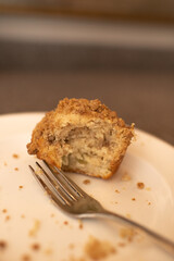 Half Eaten Banana Nut Muffin on Plate with a Fork and Crumbs 