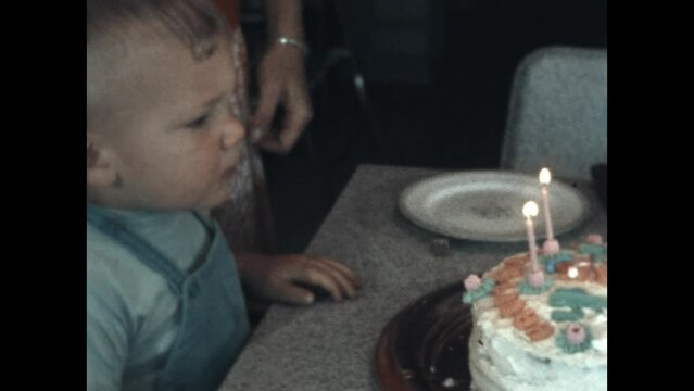 Toddler Birthday 1955 - A toddler turns two and has difficulty blowing out his birthday candles