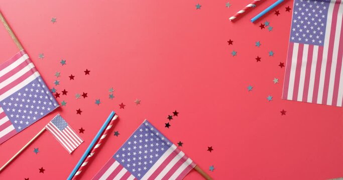 National flags of usa with stars and straws lying on red background with copy space