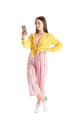 Pretty young woman with smartphone against white background