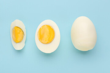 Delicious boiled eggs on blue background