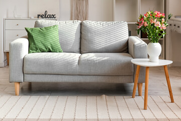 Interior of stylish living room with beautiful alstroemeria flowers