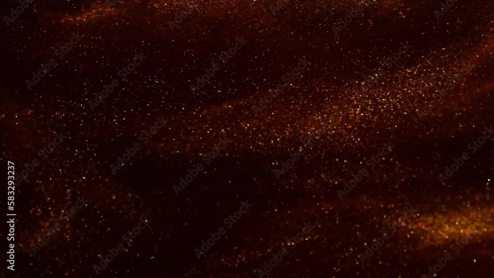 Sticker gold particles dispersion in red fluid. gold dust particles floating and flying apart in red fluid. 