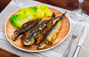 Crunchy grilled sardines garnished with fresh vegetable salad, typical dish of Portuguese cuisine