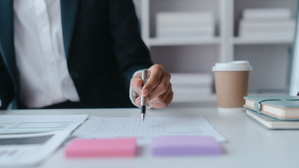 Holding pen, writing notes, Close up hands of asian bookkeeper female working with stack of papers and balance sheet with bureaucracy hardworking in office desk.