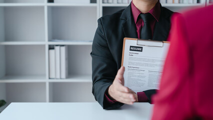 Close up view of job interview with applicant with resume paper in office, Recruitment, Job application concept.