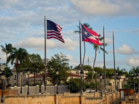 The Puerto Rican Flag and the US Stars and Stripes fly at the waterfront of Old San Juan