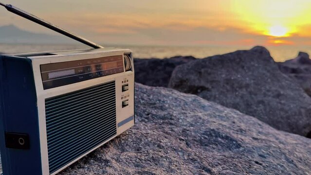 Searching For Radio Channels With Pocket Radio On A Cloudy Day At The Sunset Footage.