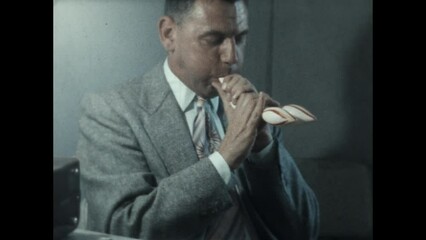 Balloon Modeling 1955 - A man inflates a large balloon animal in the 1950s