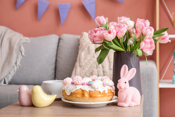 Obraz na płótnie Canvas Easter cake, bunny, porcelain quails and vase with tulip flowers on table in living room