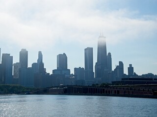Naklejka premium Clouds blow in off of Lake Michigan as Chicago's impressive skyline looms above the shoreline