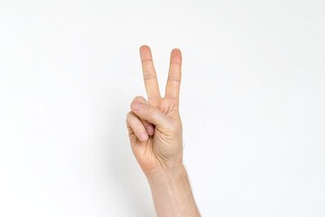 man demonstrates peace gesture on a white background