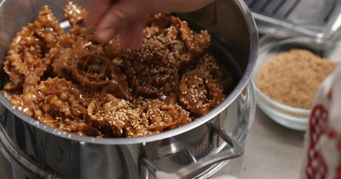 Adding sesame seeds to Chebakia enhances its flavor and texture, creating a delightful balance of nuttiness and sweetness in this traditional Moroccan pastry
