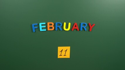 Hand sticking a sticker 11 February calendar day on school board. 11 date of February. Eleventh day of February. 11th date number. 11 day calendar. Eleven date