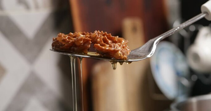 Golden wonders take a honey dip: chebakia undergoes the final stage, absorbing the golden sweetness for a decadent finish.